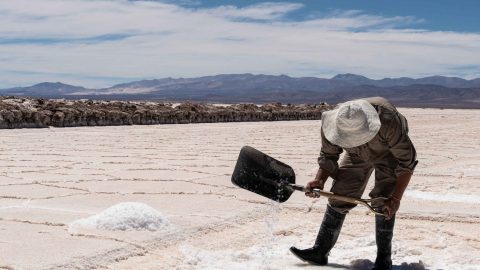 Man using a shovel in a salt production facility