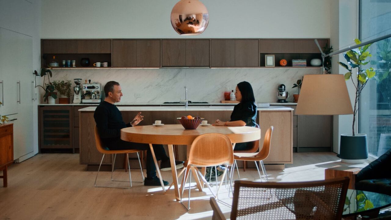 Couple sit on a table, face to face