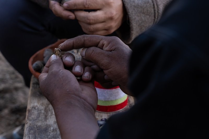 A close up of hands holding rock