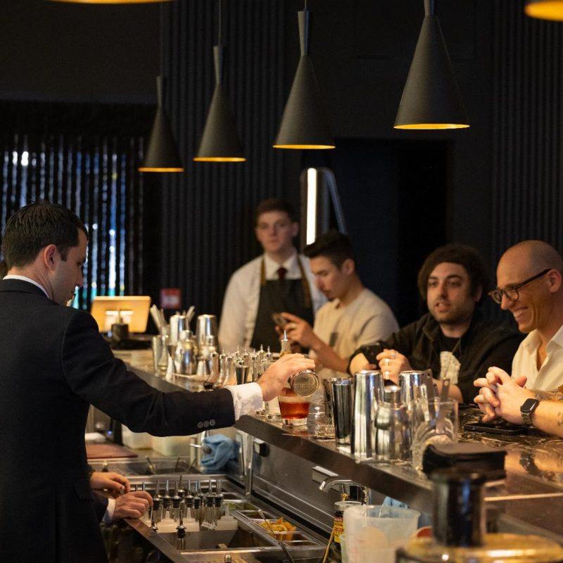 barman preparing a cocktail while watched