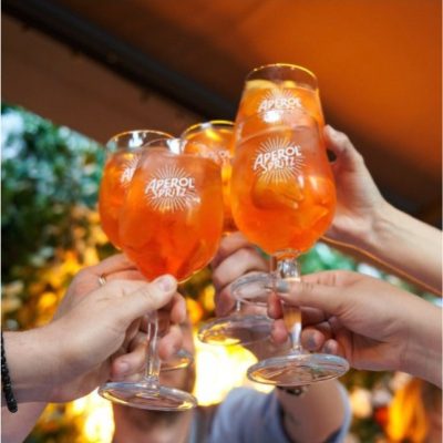 People raising Aperol glasses