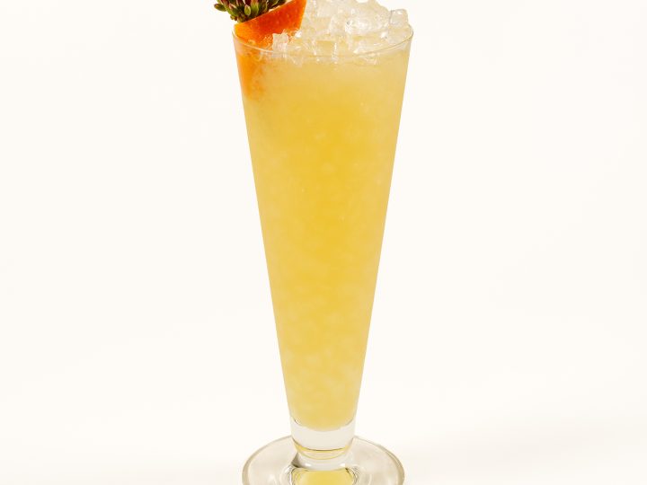 A tropical tiki cocktail with flower garnish.