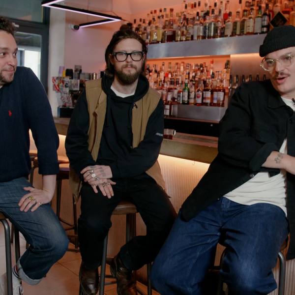 Three men talking in a bar