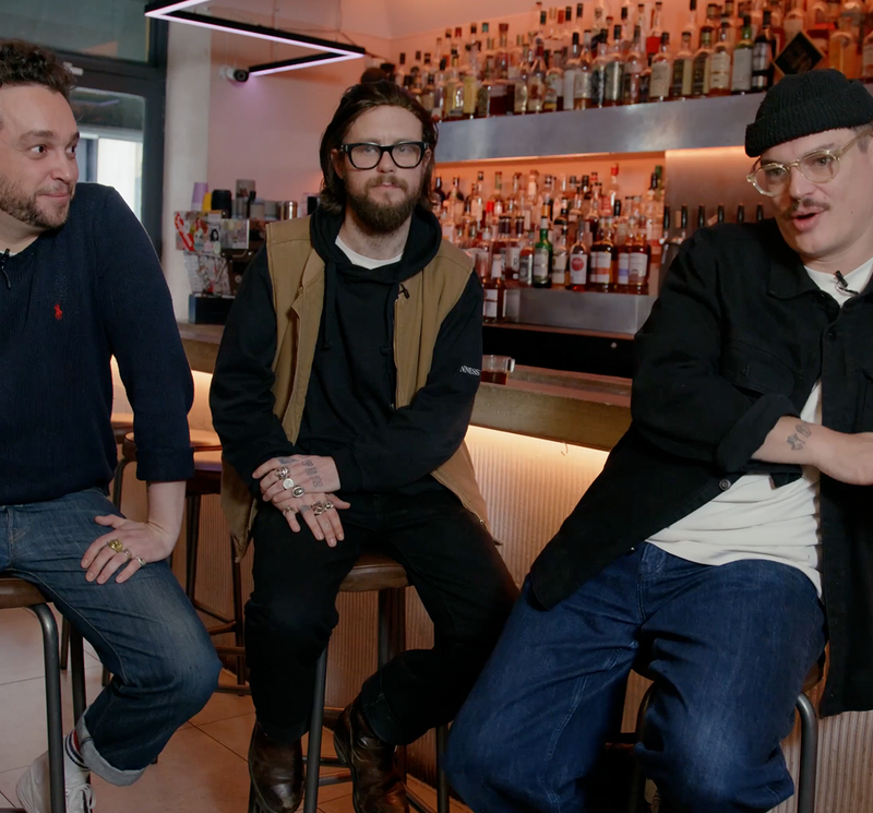 Three men talking in a bar