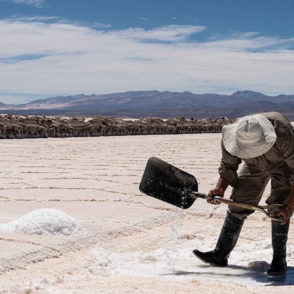Man using a shovel in a salt production facility