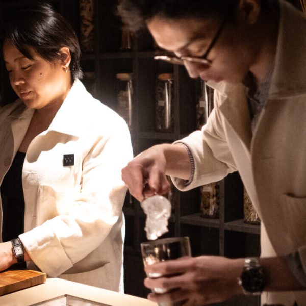 Two people preparing drinks