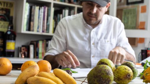 A man select fruits on a table