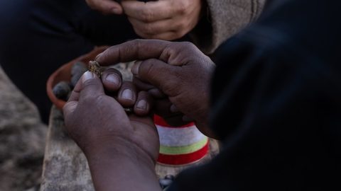 A close up of hands holding rock